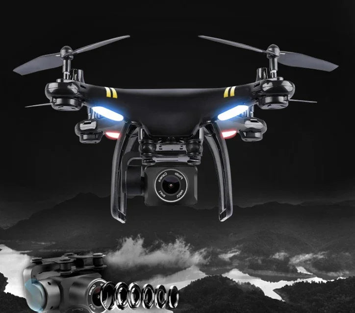 Black quadcopter drone with HD camera and LED lights flying over a mountain landscape