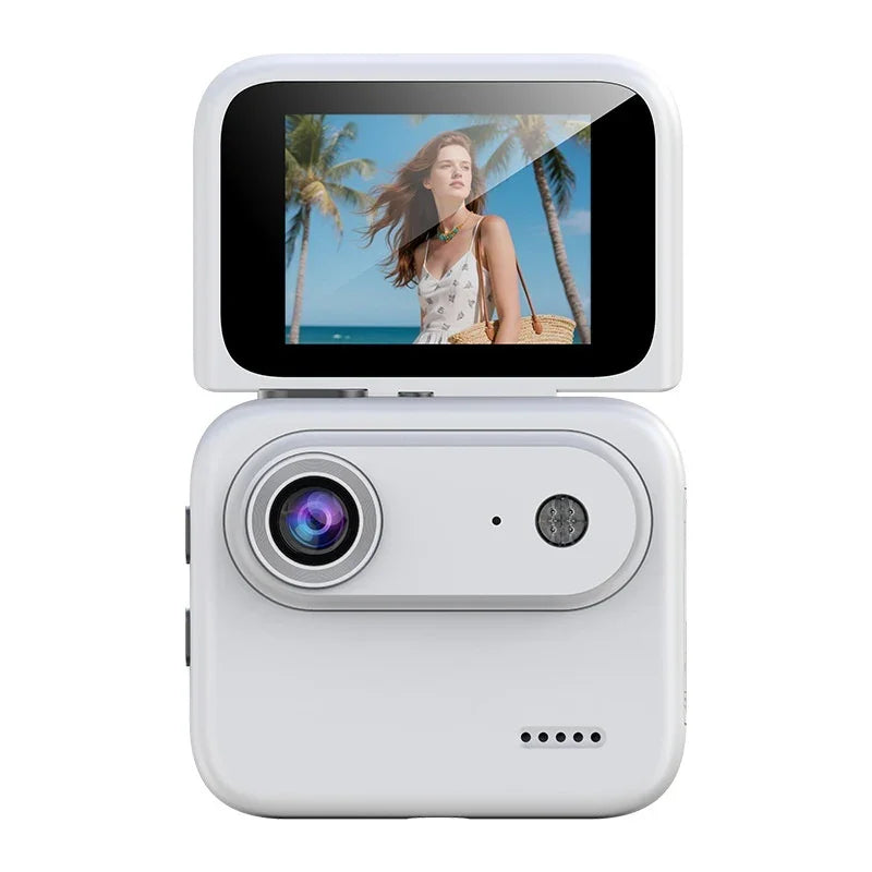 White compact digital camera with flip-up LCD screen displaying beach and palm trees