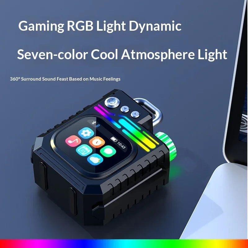 Compact gaming RGB light speaker with seven-color LED display beside a laptop