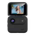 Black digital action camera with flip screen displaying woman on tropical beach